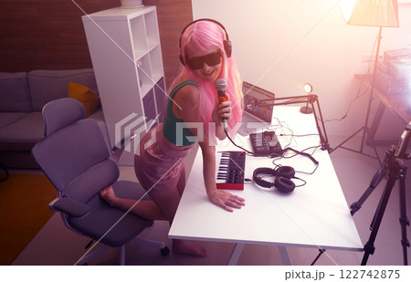 Beautiful young singer and musician broadcast from her home studio 122742875