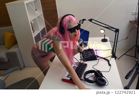 Beautiful young singer and musician broadcast from her home studio Beautiful young singer and musician broadcast from her home studio 122742921