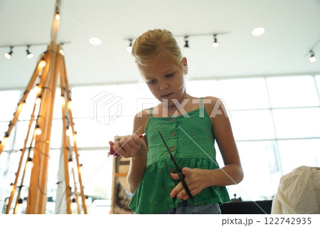 Mother and her daughter paint Halloween cookies Mother and her daughter paint Halloween cookies 122742935