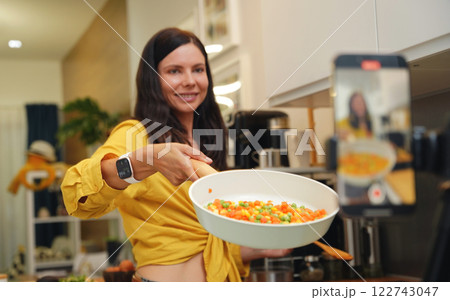 Young woman is broadcasting live from workshop how to prepare a vegetarian food 122743047