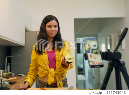 Young woman is broadcasting live from workshop how to prepare a vegetarian food 122743048