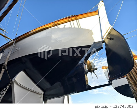 A lifeboat is securely tied to the mast of a sailing vessel A lifeboat is securely tied to the mast of a sailing vessel 122743302