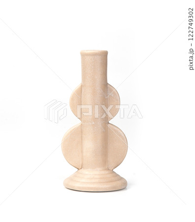 Modern ceramic candle holder with a geometric design in matte beige. A stylish and minimalist decor 122749302