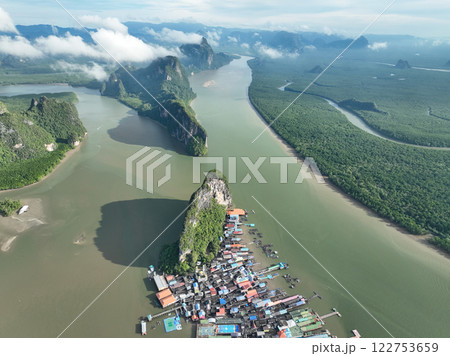Aerial view drone shot of mountains tropical rainforest with clouds over sea 122753659