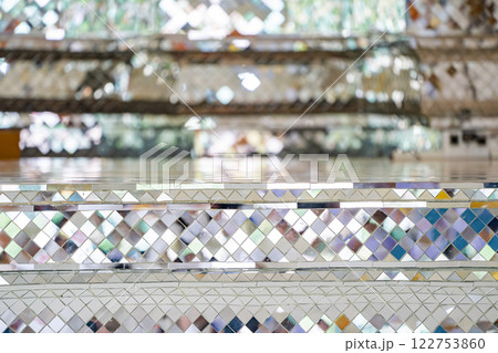 Buddhist Temple pillars and bas of pillars are decorated with Mosaic mirror. Traditional Thai temple pillar decorated with beautiful mosaic pattern inside the Buddhist temple. 122753860