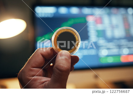 Crypto trade, investment and hand with coin in front of online trading screen data update. Fintech business, stock and digital exchange of profit and wealth with virtual money technology. Crypto trade, investment and hand with coin in front of online trading screen data update. Fintech business, stock and digital exchange of profit and wealth with virtual money technology. 122756687