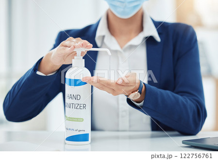 Compliance, hygiene and covid regulations with hand sanitizer and business woman in a corporate, office. Employee cleaning hands before shift, disinfecting desk and workspace while social distancing 122756761