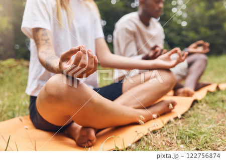 Park yoga meditation, zen and mudra hands gesture in lotus pose for nature exercise and workout. Calm energy, healthy and focus people with legs crossed training for peace, wellness balance and relax 122756874
