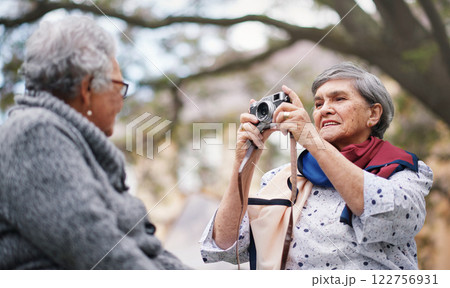 Camera, senior women and photography in nature, memories and having fun in outdoors or garden. Elderly people, friendship and picture on vacation, holiday and relaxing together at park in retirement Camera, senior women and photography in nature, memories and having fun in outdoors or garden. Elderly people, friendship and picture on vacation, holiday and relaxing together at park in retirement 122756931