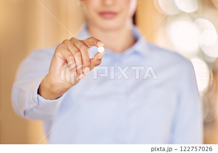 Medical pharmacy woman hand holding white tablet medication closeup. Pharmacist pills, healthcare doctor medicine prescription and illness treatment with oral capsule or vitamin closeup 122757026