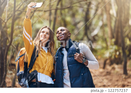 Selfie, happy couple and hiking adventure while holding phone for vacation travel memories in a forest or woods. Happy, love and exercise in healthy relationship with black man and white woman 122757237