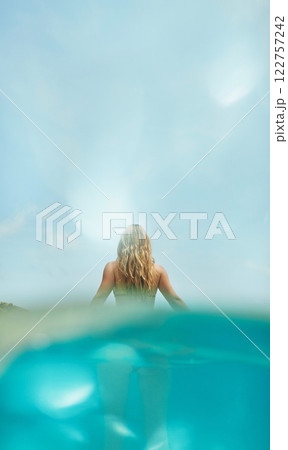 Woman, swimming and tropical island adventure for nature explore, summer vacation in bikini. Female person, discover journey and sea travel for exotic underwater on coast or paradise, trip in outdoor 122757242