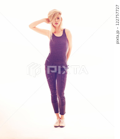 Fashion, model and beauty with a young woman posing in studio against a white background with creative lighting. Portrait of a sexy female looking sensual, elegant and confident in purple clothes 122757727