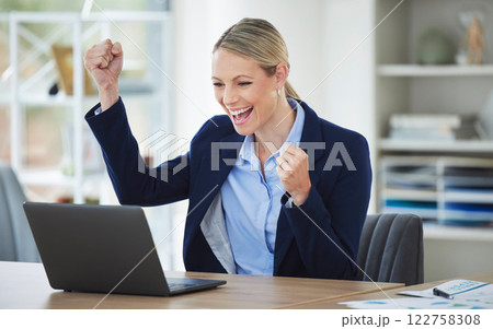 Happy, excited and success business woman celebrating with laptop online, winning and cheering for achievement while working in office at work. Corporate and professional worker receiving good news 122758308