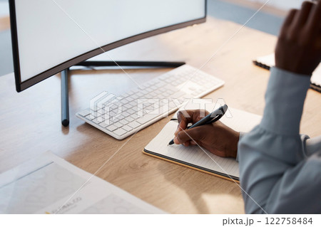 Writing ideas, planning business worker in an office with notebook and blank desktop computer monitor looking online for inspiration. Professional writer or journalist making notes for online website Writing ideas, planning business worker in an office with notebook and blank desktop computer monitor looking online for inspiration. Professional writer or journalist making notes for online website 122758484
