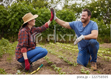 Teamwork, agriculture and collaboration high five farmer couple planting organic crops while bonding. Sustainability farm partners excited to go green and begin new business with fresh vegetables Teamwork, agriculture and collaboration high five farmer couple planting organic crops while bonding. Sustainability farm partners excited to go green and begin new business with fresh vegetables 122758505