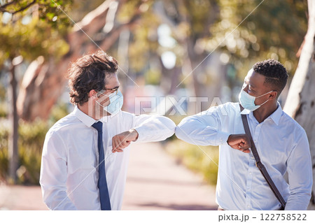 Covid greet, social distancing and elbow bump by business men meeting and greeting outdoors. Happy, friendly and excited colleagues using covid19 prevention protocol and wearing masks Covid greet, social distancing and elbow bump by business men meeting and greeting outdoors. Happy, friendly and excited colleagues using covid19 prevention protocol and wearing masks 122758522