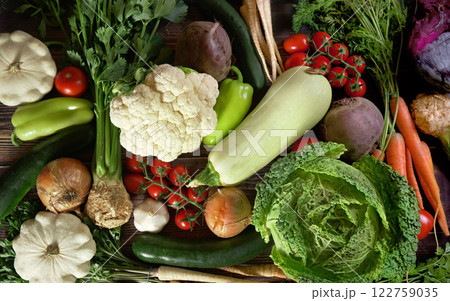 Top down view, group of various vegetables on dark wood board. Healthy vegetable concept Top down view, group of various vegetables on dark wood board. Healthy vegetable concept 122759035