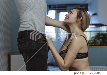 Work with your mouth. Sexy girl rubs the zipper on her partner's jeans for oral sex 122760530