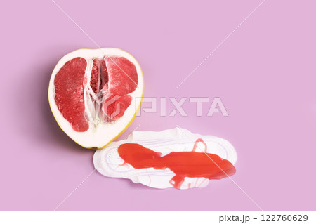 Menstruation in ginseng and critical days. Grapefruit symbolizes the vagina and next to the pad on which the slime is in the form of blood Menstruation in ginseng and critical days. Grapefruit symbolizes the vagina and next to the pad on which the slime is in the form of blood 122760629