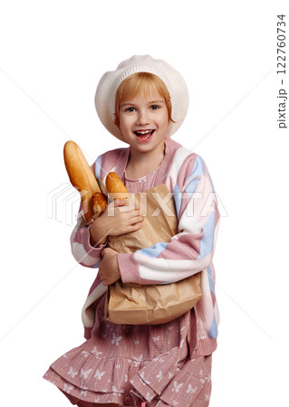 Young baker girl holding baguettes isolated on white background with copy space Young baker girl holding baguettes isolated on white background with copy space 122760734