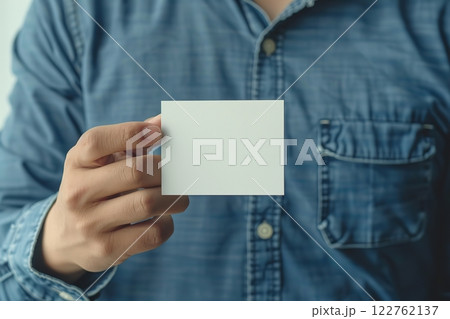 Male hand holds an empty white business card. Clean blank flyer in businessman arm. For your text. Business communication company entrepreneur concept. Man holding showing white single business card 122762137