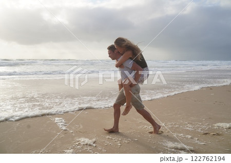 Loving couple playing on ocean beach 122762194