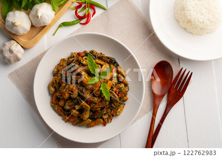 Stir fried green mussel with thai holy basil in white plate.Thai spicy food.Top view. Stir fried green mussel with thai holy basil in white plate.Thai spicy food.Top view. 122762983