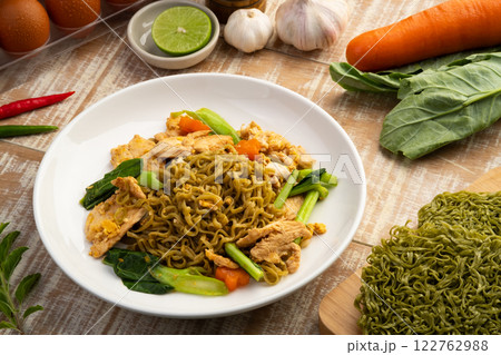 Stir fried instant Japanese style vegetable noodles with Soy Sauce and chicken breast in white plate.Asian food with low calories and healthy food.Thai style. Stir fried instant Japanese style vegetable noodles with Soy Sauce and chicken breast in white plate.Asian food with low calories and healthy food.Thai style. 122762988