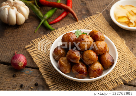 Thai Sausage Feast,fermented pork and rice sausage (Sai Krok Isan) in white plate with vegetables Thai Sausage Feast,fermented pork and rice sausage (Sai Krok Isan) in white plate with vegetables 122762995