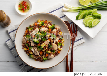 Healthy asian food.Thai fried Organic Red Brown Jasmine Rice (unpolished rice) with chicken breast and broccoli carrot egg in white plate.clean food.Top view. 122763022