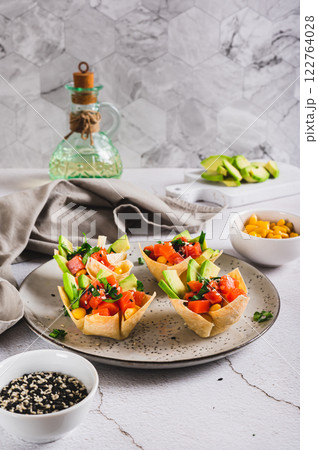 Mini poke bowls in pita bread on a plate on the table vertical view Mini poke bowls in pita bread on a plate on the table vertical view 122764028