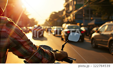 With style and speed, the motorcyclist navigates urban traffic, leaving behind a trail of excitement. 122764539