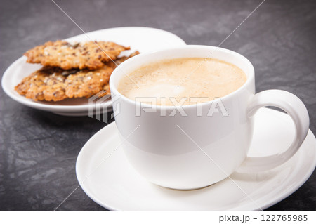 Cup of coffee with milk and fresh baked oatmeal cookies with honey Cup of coffee with milk and fresh baked oatmeal cookies with honey 122765985