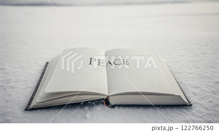 Open Book Displaying the Word Peace Resting on Pristine Snow 122766250