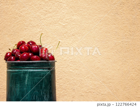 Fresh cherries on a peach background, a healthy eating concept, with space for text Fresh cherries on a peach background, a healthy eating concept, with space for text 122766424