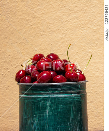 Fresh cherries on a peach background, a healthy eating concept, with space for text 122766425