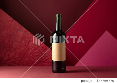 Bottle of red wine on a red background. Bottle of red wine on a red background. 122766770