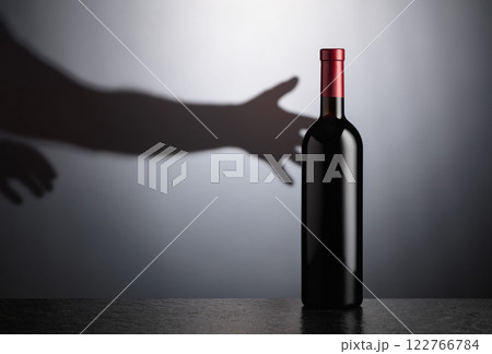 Bottle of red wine on a black table. 122766784