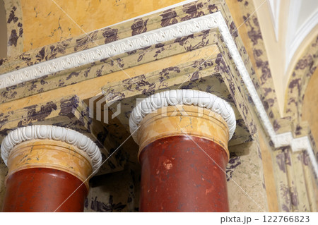 Stone pillars with stone capitals are under ceiling, classic architecture Stone pillars with stone capitals are under ceiling, classic architecture 122766823