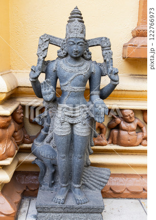 Ancient stone statue stands at the entrance of Gangaramaya Temple Ancient stone statue stands at the entrance of Gangaramaya Temple 122766973
