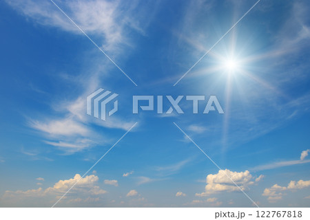 Sun on beautiful blue sky with fluffy clouds. 122767818