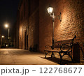 A serene night scene with a wooden bench beside a brick wall. Generated AI. 122768677
