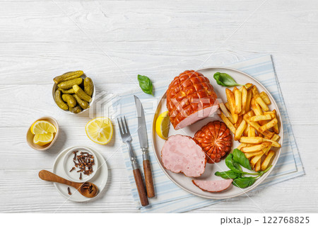 boneless smoked ham with fried potatoes on plate 122768825