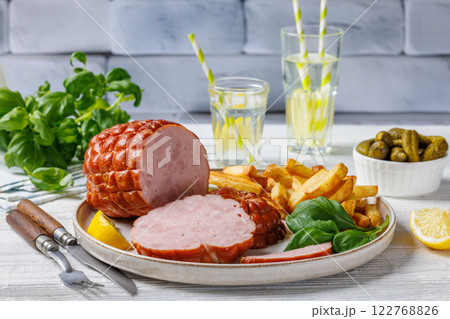 boneless smoked ham with fried potatoes on plate 122768826