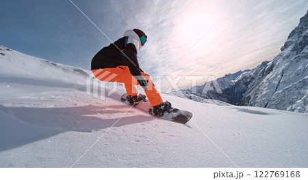 Extreme snowboarder riding in powder snow and doing turns. Extreme snowboarder riding in powder snow and doing turns. 122769168