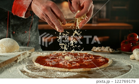 Freeze motion of pizza maker preparing fresh pizza. 122769179