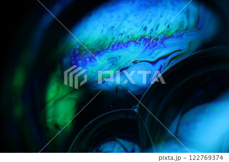 Bright rainbow reflection of liquid on black background, blue surface, surrealistic background, fantastic surface movement, beautiful science Bright rainbow reflection of liquid on black background, blue surface, surrealistic background, fantastic surface movement, beautiful science 122769374