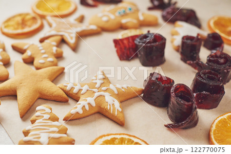Decorating gingerbread cookies with white icing, selective focus and place for text Decorating gingerbread cookies with white icing, selective focus and place for text 122770075
