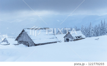 Cabin in the mountains in winter. Mysterious fog. In anticipation of holidays. Carpathians. Ukraine, Europe Cabin in the mountains in winter. Mysterious fog. In anticipation of holidays. Carpathians. Ukraine, Europe 122770203